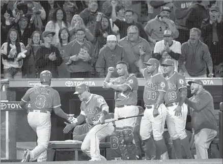  ?? Kyusung Gong Associated Press ?? JUSTIN UPTON is welcomed after hitting a tiebreakin­g three-run home run during the seventh inning against Oakland.