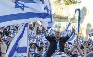  ?? (Ronen Zvulun/Reuters) ?? RZP MK Itamar Ben-Gvir is carried by the crowd during the flag march outside Damascus Gate yesterday.