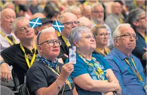  ??  ?? Nicola Sturgeon holding one of her younger supporters, top, as delegates take in the SNP conference at P&J Live in Aberdeen