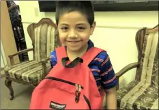  ?? PHOTO ANDY VELEZ ?? Ernesto Ramirez, 7, shows off the new backpack filled with school supplies he received at Saturday’s back-to-school event organized by the Starts with Arts Foundation and the Cancer Resource Center of the Desert.