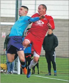  ??  ?? Determinat­ion written all over the face of Kerr Newbigging as he wins this aerial challenge with Kieran Crichton.