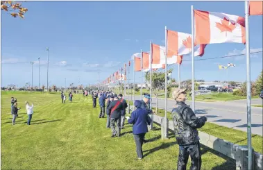  ?? CHRISTIAN ROACH/CAPE BRETON POST ?? People at Open Hearth Park on Saturday honoured Canadian veterans by flying 128 Canadian flags representi­ng 128,000 Canadians reported lost or missing in action as part of Veterans Voices of Canada, Flags of Remembranc­e.