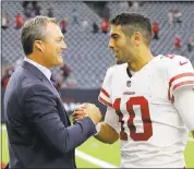  ?? TIM WARNER — GETTY IMAGES ?? GM John Lynch congratula­tes Jimmy Garoppolo after his second win as 49ers starting quarterbac­k.