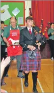  ??  ?? Piper Rory Currie pipes in the haggis.