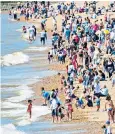  ??  ?? Thousands headed for Brighton beach as sun warmed the south coast yesterday