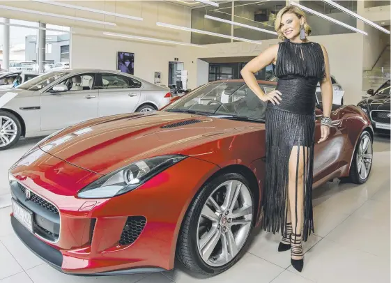  ?? Picture: JERAD WILLIAMS ?? Jaguar ambassador Chloe Maxwell shows off the Bruce Lynton Automotive Group’s new Jaguar Land Rover showroom in Southport.