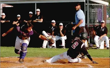  ?? MARK HUMPHREY ENTERPRISE-LEADER ?? Toby Rose straddles the plate to elude a tag and score versus Elkins. Rose scored 7 runs on the year for Lincoln.