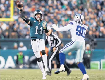  ?? AP ?? Eagles quarterbac­k Carson Wentz, left, throws a pass against the Cowboys in Philadelph­ia.