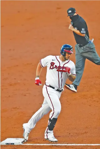  ?? AP PHOTO/JOHN BAZEMORE ?? The Atlanta Braves’ Matt Adams rounds third base after hitting a home run in the second inning against the Toronto Blue Jays Tuesday in Atlanta. The Braves won 10-1.