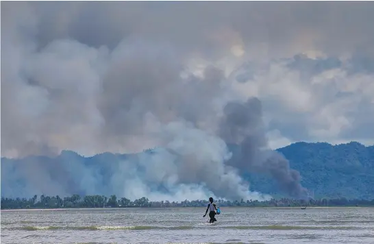  ?? Pictures / AP ?? From across the border in Bangladesh, smoke can be seen rising from what once were villages in Rakhine state, Burma.