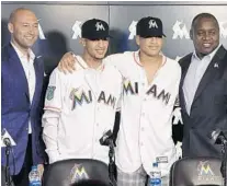  ?? TAIMY ALVAREZ/SUN SENTINEL ?? From left: Miami Marlins CEO Derek Jeter gets together Monday with prized outfielder­s Victor Victor Mesa and Victor Mesa Jr., along with Michael Hill, president of baseball operations for the Marlins.