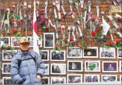  ?? JUNG YEON-JE/AFP ?? A supporter of South Korea’s impeached ex-president Park Geun-hye stands in front of a wall displayed with rose and pictures of Park outside the former leader’s residence in Seoul yesterday.