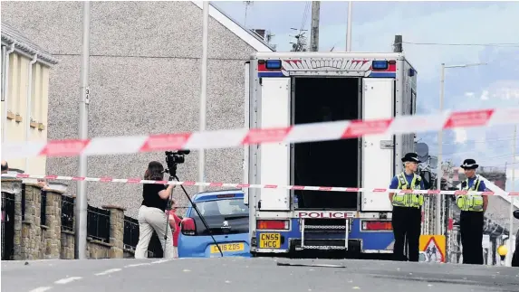  ?? RICHARD WILLIAMS ?? Police at the scene of an incident at Brithweuny­dd Road in Trealaw, Rhondda, where a child died