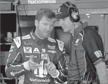  ?? Chuck Burton / The Associated Press ?? Dale Earnhardt Jr. (left) talks with crew chief Greg Ives during practice for today’s race at Charlotte Motor Speedway.