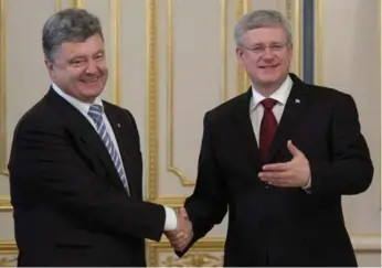  ?? ADRIAN WYLD/THE CANADIAN PRESS ?? Stephen Harper meets with Petro Poroshenko, who took his oath of office as president of Ukraine on Saturday.