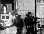  ?? ABDESSLAM MIRDASS/GETTY-AFP ?? Police officers stand guard near the scene of a shooting Tuesday in Strasbourg, France.