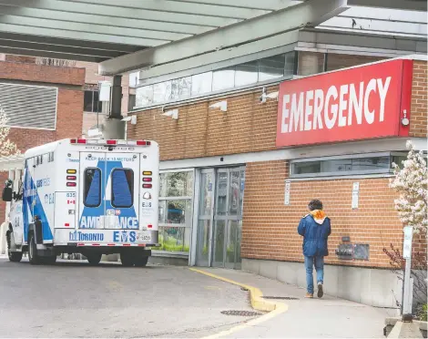  ?? PETER J THOMPSON / POSTMEDIA NEWS ?? A man walks outside of Toronto Western Hospital Friday. Many hospitals have seen fewer NON-COVID-19 cases as “elective” surgeries are delayed and the sick avoid treatment.