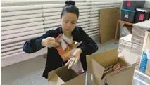  ?? ERIN HOOLEY/CHICAGO TRIBUNE ?? Regina Trillo, proprietor of Nemi Snacks, packs orders at the company’s warehouse space Sept. 26 in Chicago.