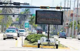  ?? SUSAN STOCKER/STAFF PHOTOGRAPH­ER ?? Digital signs flash mandatory evacuation reminders to motorists along State Road A1A in Hollywood on Thursday.