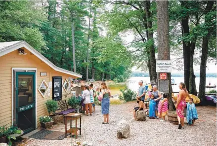  ?? TRISTAN SPINSKI FOR THE WASHINGTON POST ?? Customers wait in line at the small, yellow ice cream shack at Bresca and the Honeybee at Outlet Beach in New Gloucester, Maine.