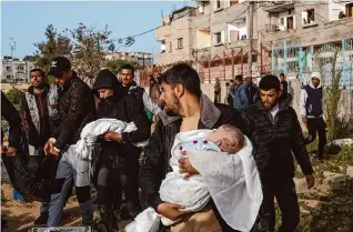  ?? Photos by Hatem Ali/Associated Press ?? Mourners on Sunday carry the bodies of Palestinia­n twins killed Saturday in an Israeli strike that destroyed a house in Rafah, in the southern Gaza Strip. Fourteen people died there.