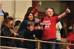  ?? (Mikala Compton/ Austin American-statesman via AP) ?? LEFT
American Principles Project members give a thumbs-up to representa­tives after the Texas House of Representa­tives passes Senate Bill 14 on May 12 in Austin. SB14 would ban gender-affirming medical care for transgende­r children.