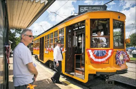  ?? Alex Driehaus/Post-Gazette photos ?? The crew of Pittsburgh Railway Streetcar #4398 waits for passengers to finish boarding the 100-year-old car at the Pennsylvan­ia Trolley Museum on Saturday.
