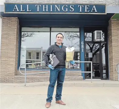  ?? DAVID BEBEE WATERLOO REGION RECORD ?? All Things Tea owner George Broughton on Thursday in Kitchener’s Belmont Village, with packages from his shop he will be delivering with his free home delivery service. He’s offering products from other small businesses as well.