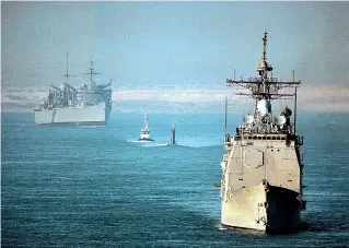  ?? TNS ?? The USS Normandy, front, is pictured transiting the Suez Canal. Sailors from the Normandy boarded a dhow earlier this month and seized antitank and surfaceto-air missiles they said were bound for Houthi rebels in Yemen.