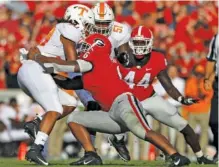  ?? STAFF PHOTO BY C.B. SCHMELTER ?? Georgia linebacker Natrez Patrick hits Tennessee running back Jeremy Banks during the teams’ SEC East matchup Sept. 29 in Athens, Ga. Banks has moved to defense and could get in a game at linebacker as soon as Saturday, when the Vols visit South Carolina.