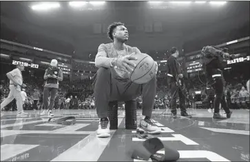  ?? Rich Pedroncell­i Associated Press ?? SACRAMENTO guard Buddy Hield waits for New Orleans to take the court before game is suspended.