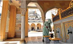  ??  ?? A woman cleans inside the Heart of Chechnya - Akhmad Kadyrov Mosque.