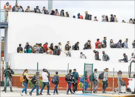  ?? Robert Gauthier Los Angeles Times ?? seekers who used the CBP One app to make appointmen­ts wait for interviews with U.S. agents at the San Ysidro crossing.