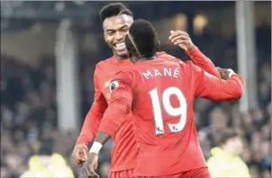  ?? OLI SCARFF/AFP ?? Liverpool midfielder Sadio Mane celebrates scoring against Everton with Reds striker Daniel Sturridge in their English Premier League match on Monday night.