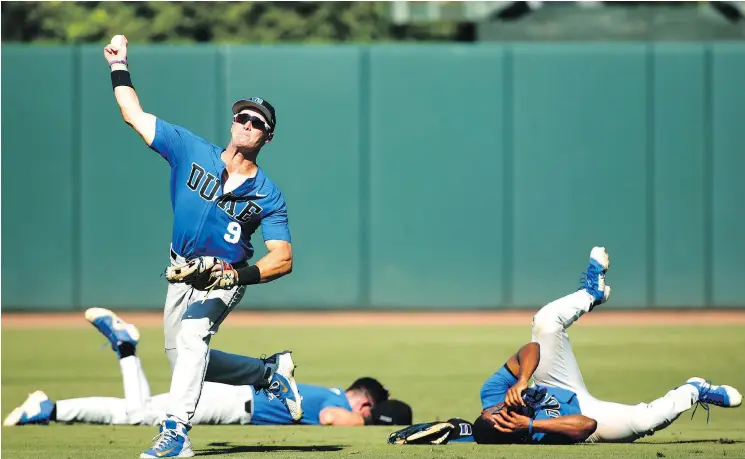  ?? JOSHUA L. JONES/ATHENS BANNER-HERALD ?? Duke University outfielder Griffin Conine fires the ball to home plate after two teammates collide in the field during action last Saturday.