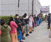  ?? — G.N. JHA, PTI ?? A medic administer­s Covishield vaccine to a frontline worker in New Delhi on Saturday. (Right) Health workers stand in a queue to get vaccinated at Rajiv Gandhi Super Speciality Hospital.