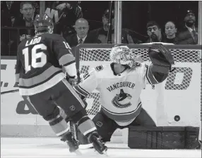  ?? The Associated Press ?? New York Islanders forward Andrew Ladd scores past Vancouver Canucks goalie Andres Nilsson during the first period Tuesday in Brooklyn.