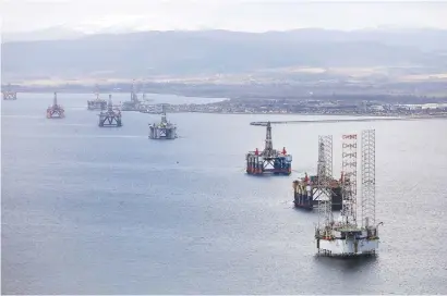  ?? Picture: Bloomberg ?? SITTING DUCKS. Mobile offshore drilling units in the Port of Cromarty Firth in Cromarty, UK. Even as oil production declined in the North Sea over the past 15 years and accessing remaining reserves became more difficult, so decomissio­ning costs have...