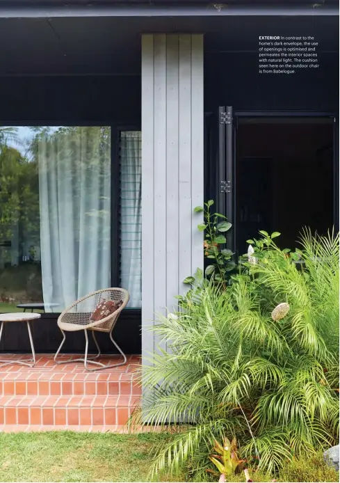  ??  ?? EXTERIOR In contrast to the home’s dark envelope, the use of openings is optimised and permeates the interior spaces with natural light. The cushion seen here on the outdoor chair is from Babelogue.