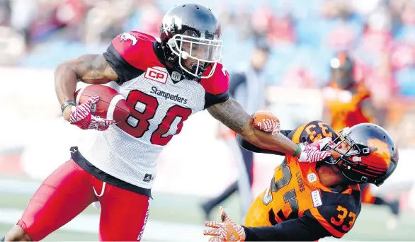  ?? JIM WELLS ?? The Stampeders’ Jamal Nixon stiff-arms the B.C. Lions’ Tevin McDonald during a pre-season game at McMahon Stadium in Calgary on Tuesday. The Stamps won 23-18.