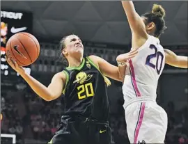  ?? Jessica Hill Associated Press ?? OREGON’S SABRINA IONESCU, battling Connecticu­t’s Olivia Nelson-Ododa, had 10 points, nine rebounds and nine assists in the Ducks’ 74-56 victory Monday.