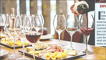  ?? ?? A close-up on a sommelier serving glasses of wine paired up with canpes at a wine tasting event.