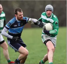  ??  ?? An Tochar’s Gerard Byrne tries to stop Paddy Byrne of Ballymanus.