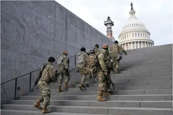  ?? The Associated Press ?? ■ National Guard members take a staircase toward the U.S. Capitol building before a rehearsal for President-elect Joe Biden’s Presidenti­al Inaugurati­on in Washington on Jan. 18, 2021. Soldiers are leaving the Army National Guard at a faster rate than they are enlisting, fueling concerns that in the coming years units around the country may not meet military requiremen­ts for overseas and other deployment­s.