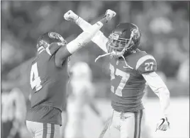  ?? Marcio Jose Sanchez ?? The Associated Press Southern California safety Chris Hawkins (4) and cornerback Ajene Harris (27) celebrate during the Pac-12 Conference championsh­ip Friday in Santa Clara, Calif.