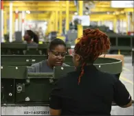  ?? (Arkansas Democrat-Gazette/Staci Vandagriff) ?? Assembly-line operators work on the High Mobility Artillery Rocket System Launchers production line at a Lockheed Martin facility in Camden on Thursday.