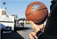  ??  ?? Warriors general manager Bob Myers, ball in hand, waits for clearance to enter San Quentin.