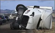  ?? (AP/The Gazette/ Christian Murdock) ?? A semi truck lies on its side along the southbound lanes of Interstate 25, just south of the Interquest Parkway exit, Friday morning after a storm with wind gusts up to 115 mph hit the Colorado Springs, Colo., area over night.