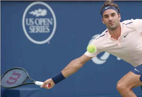  ?? — USA Today Sports ?? Roger Federer of Switzerlan­d hits a shot against David Ferrer of Spain (not pictured) during the Rogers Cup at Uniprix Stadium.