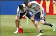  ?? RICARDO MAZALAN — THE ASSOCIATED PRESS ?? Lionel Messi collects field marks during a training session of Argentina at the 2018 soccer World Cup in Bronnitsy, Russia, Sunday.